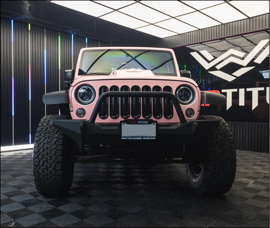 Pink colour-change wrapped Jeep Wrangler inside a Wraptitude studio